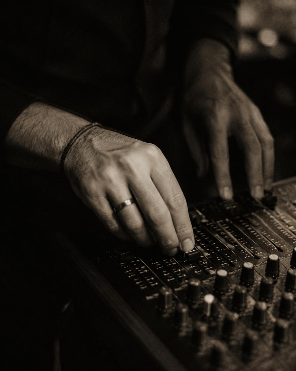 AnthonieDeluxe adjusting a mixer in low warm light