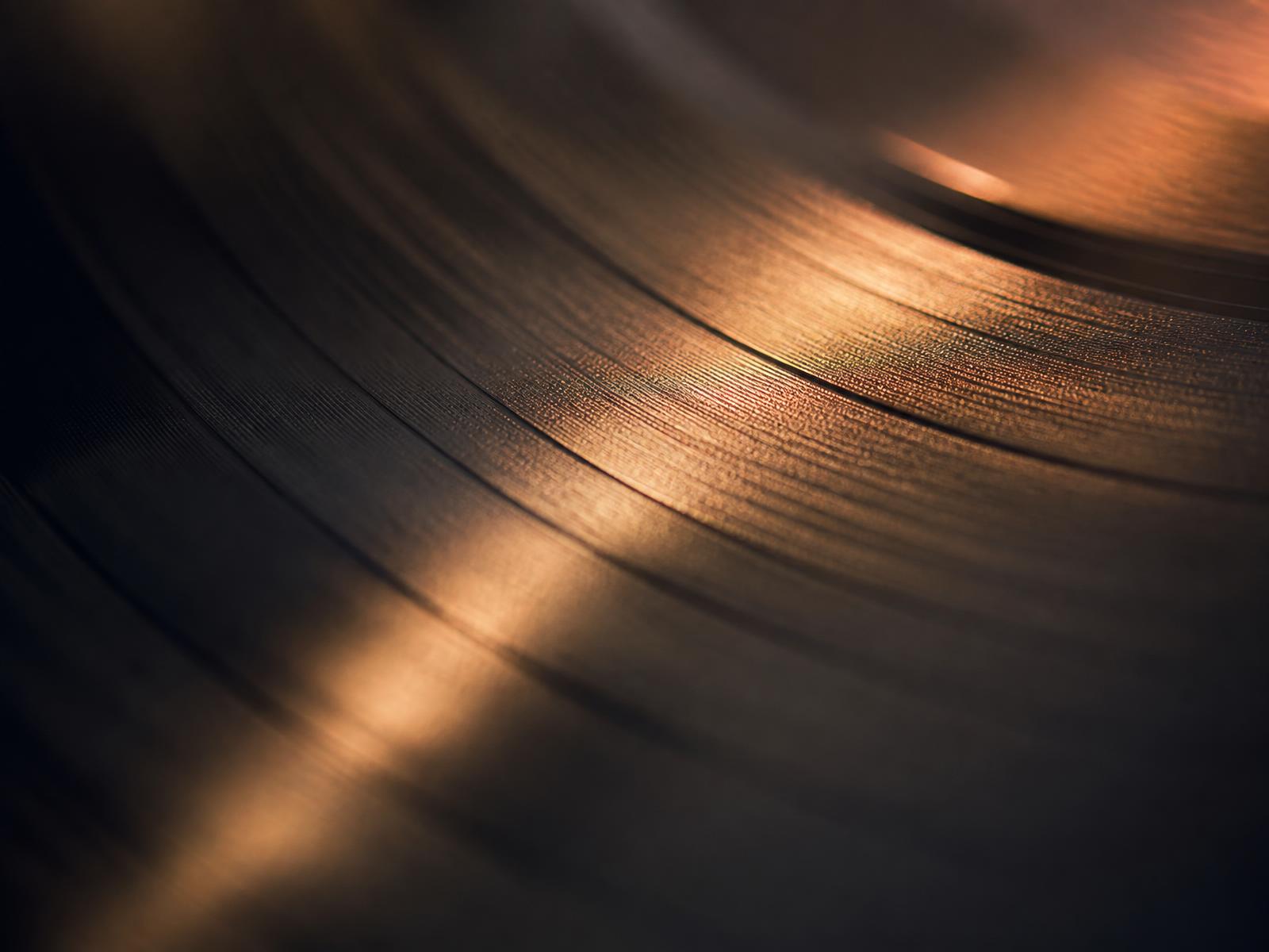 Macro detail of vinyl grooves catching warm light